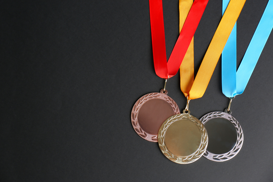 Gold, Silver and Bronze Medals on Black Background, Flat Lay. Sp